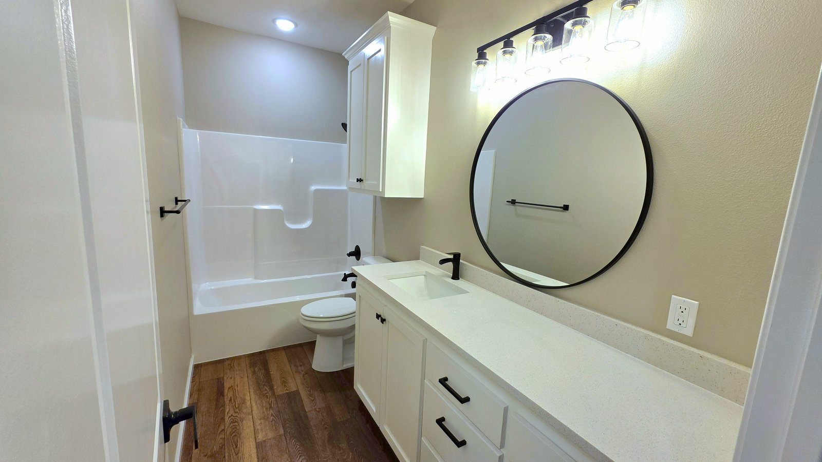 Bathroom double vanity with round mirrors and black hardware