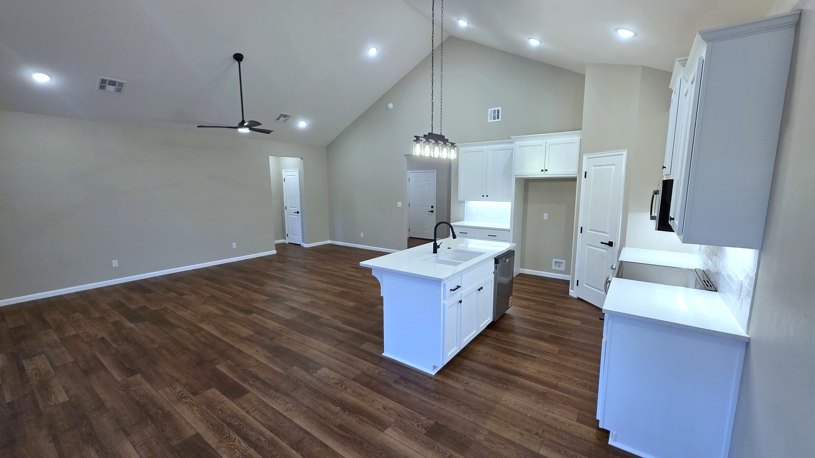 Updated kitchen with white cabinetry and island for daily living or resale presentation