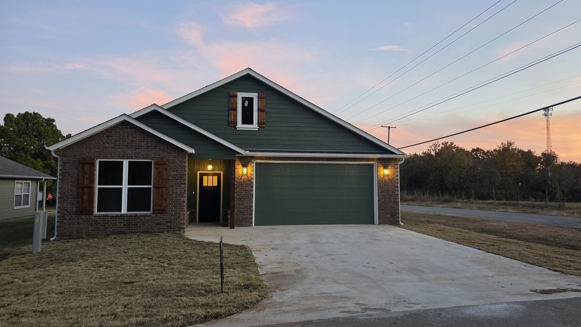 Custom home exterior at twilight suited to Green Country and lake-area living