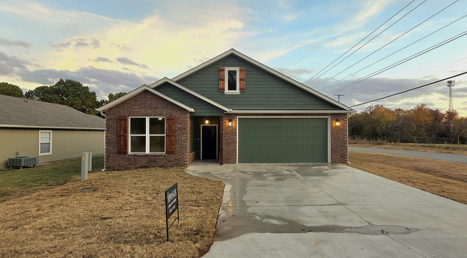 Front elevation of green and brick custom home